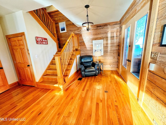 living area featuring hardwood / wood-style floors and wooden walls