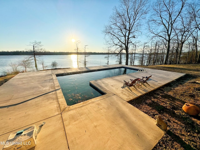 view of pool featuring a patio area and a water view