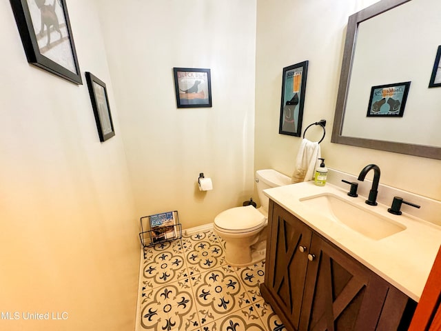 bathroom featuring tile patterned floors, toilet, and vanity