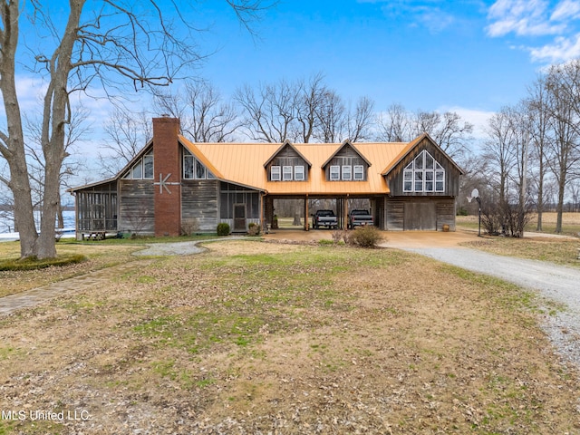 view of front facade with a sunroom and a carport