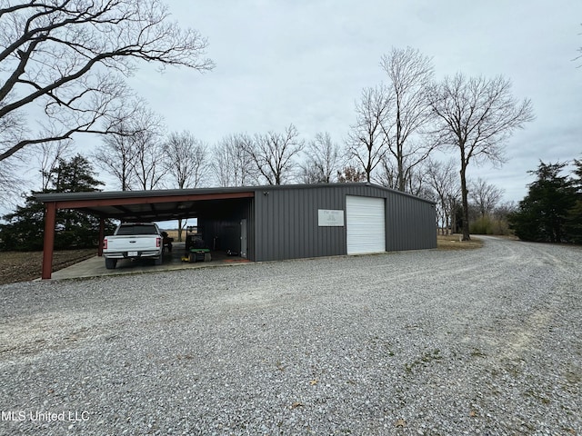 view of outbuilding with a garage and a carport