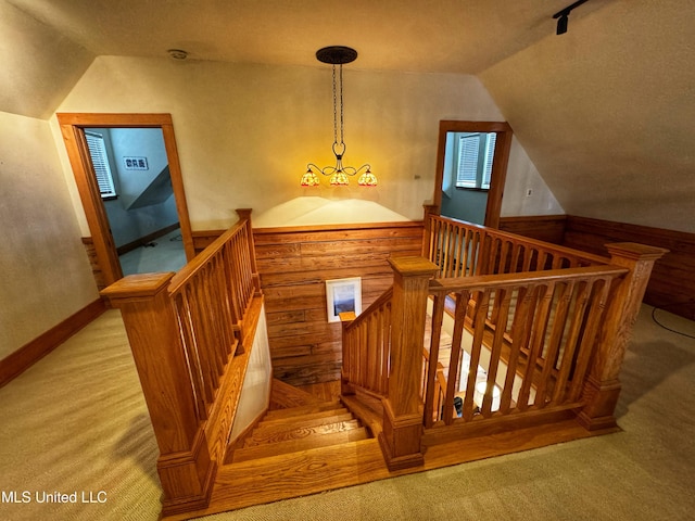 stairway featuring lofted ceiling