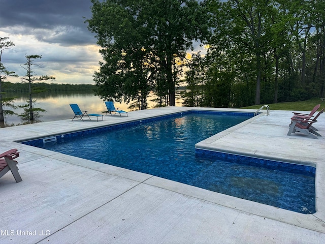 outdoor pool featuring a patio and a water view