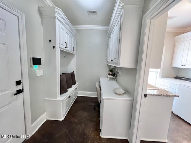 mudroom featuring ornamental molding and independent washer and dryer