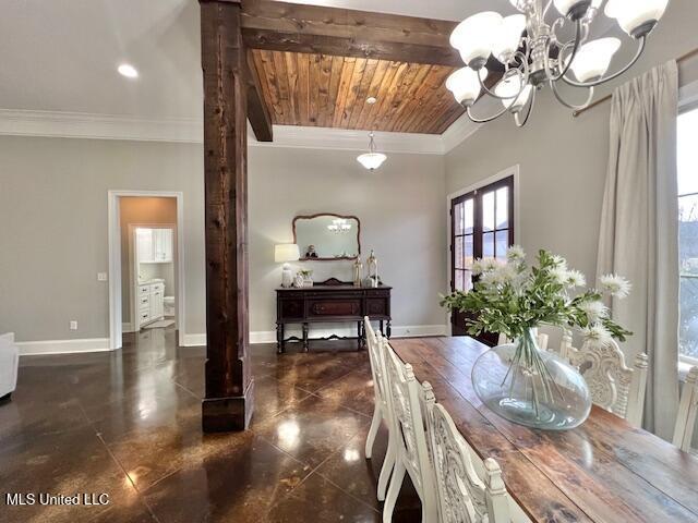 dining space with wood ceiling, crown molding, and a chandelier