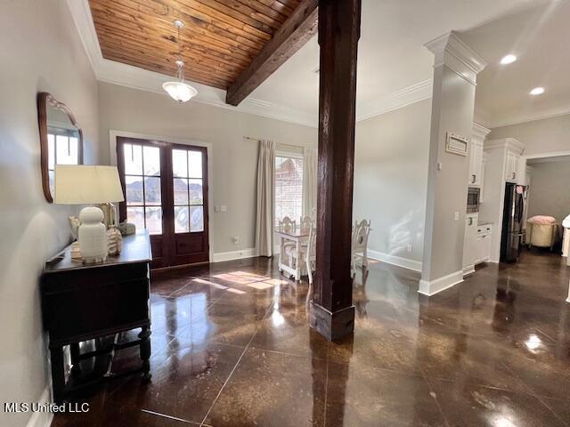 entrance foyer featuring beam ceiling, crown molding, wood ceiling, and ornate columns