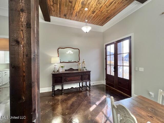 entrance foyer featuring french doors, crown molding, and wooden ceiling