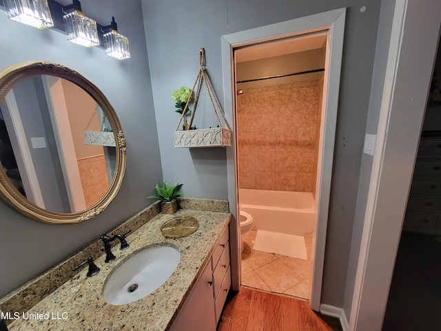 166 Lee Ave, Vidalia, LA 71373 - full bath with wood finished floors, vanity, toilet, and washtub / shower combination