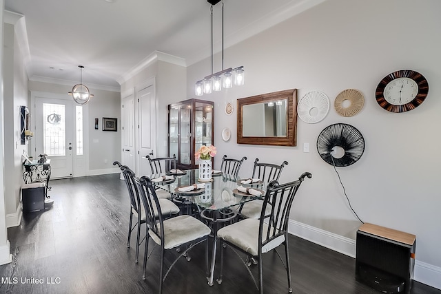 dining room with ornamental molding and dark hardwood / wood-style flooring