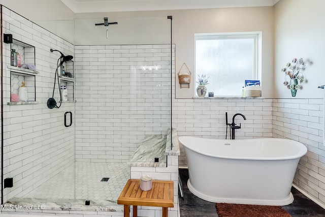 bathroom with independent shower and bath and tile walls