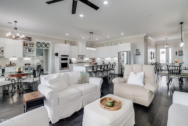 living room featuring ornamental molding, sink, ceiling fan, and dark hardwood / wood-style flooring