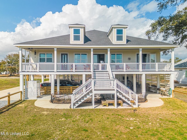 rear view of property with a yard, covered porch, and a patio area