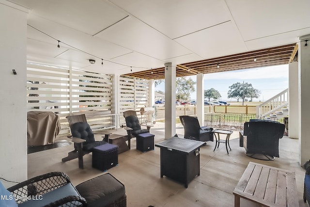 view of patio featuring grilling area and an outdoor living space with a fire pit