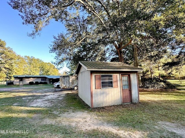 view of outbuilding featuring a lawn