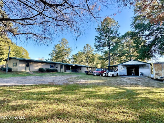 exterior space with a garage, an outdoor structure, and a front yard