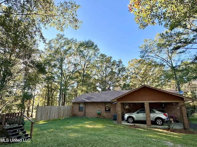 exterior space with a carport and a lawn