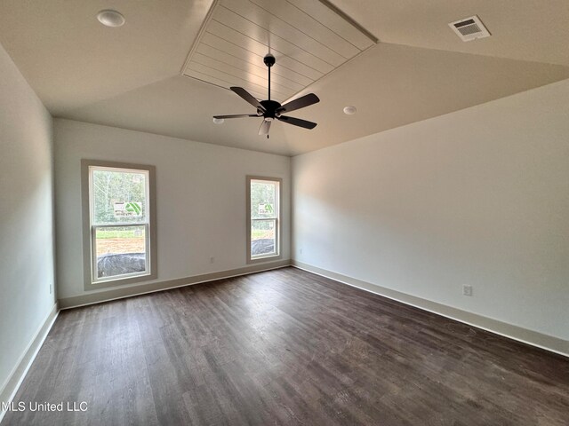 empty room featuring ceiling fan, lofted ceiling, and dark hardwood / wood-style flooring