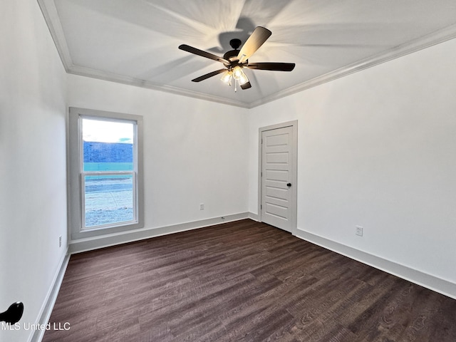 empty room with crown molding, dark wood-type flooring, and ceiling fan