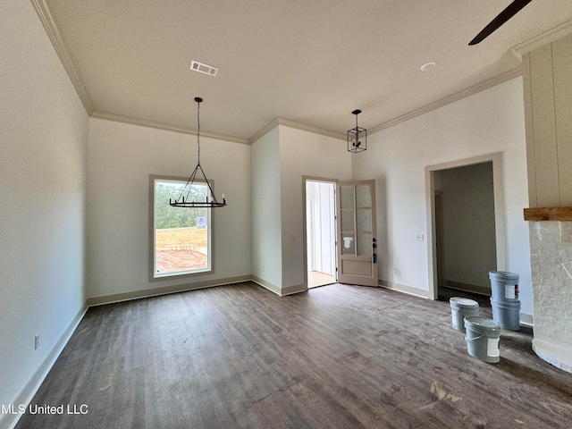 unfurnished dining area with ornamental molding and dark hardwood / wood-style floors