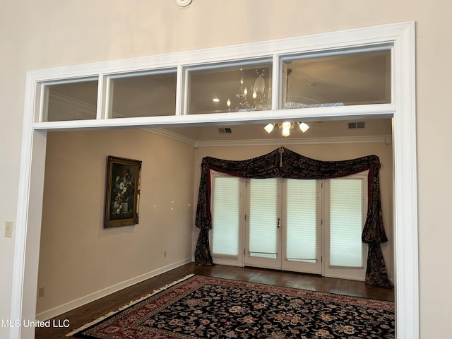 8136 Saddlebrook Cv, Olive Branch, MS 38654 - empty room featuring wood finished floors, ornamental molding, and french doors