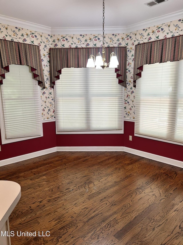 8136 Saddlebrook Cv, Olive Branch, MS 38654 - unfurnished dining area with wallpapered walls, a chandelier, crown molding, dark wood-type flooring, and plenty of natural light