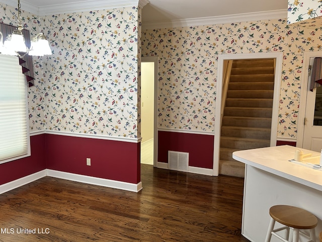 8136 Saddlebrook Cv, Olive Branch, MS 38654 - unfurnished dining area with wallpapered walls, a chandelier, crown molding, wood finished floors, and wainscoting