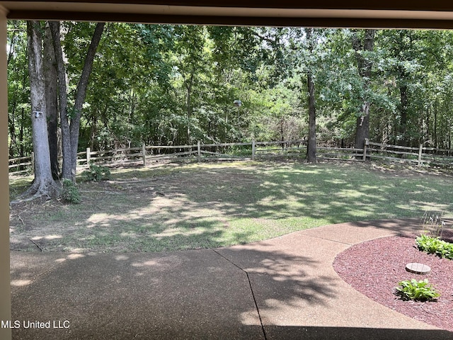 8136 Saddlebrook Cv, Olive Branch, MS 38654 - fenced backyard featuring a patio area and a wooded view