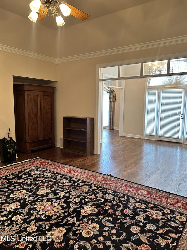 8136 Saddlebrook Cv, Olive Branch, MS 38654 - unfurnished living room featuring wood finished floors, ornamental molding, and a ceiling fan