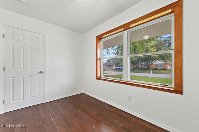 spare room featuring dark wood-type flooring