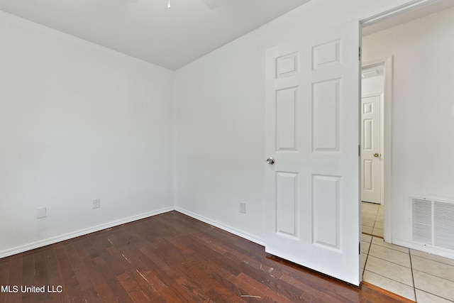 unfurnished room with hardwood / wood-style floors