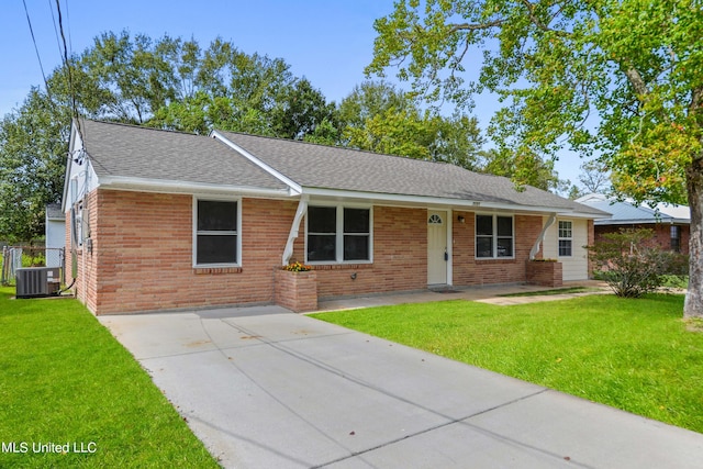 ranch-style house with a front lawn and central air condition unit