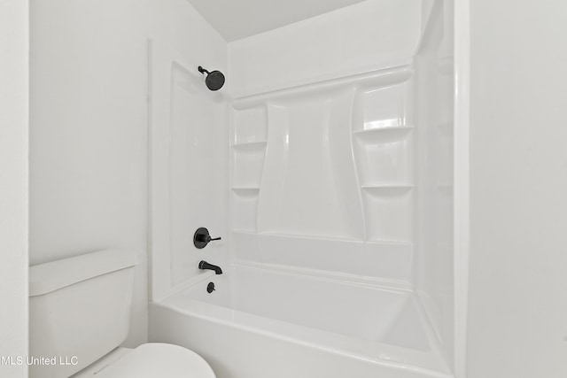 bathroom featuring shower / tub combination and toilet