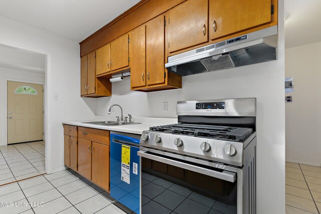 kitchen featuring light tile patterned flooring, dishwasher, sink, and stainless steel gas range