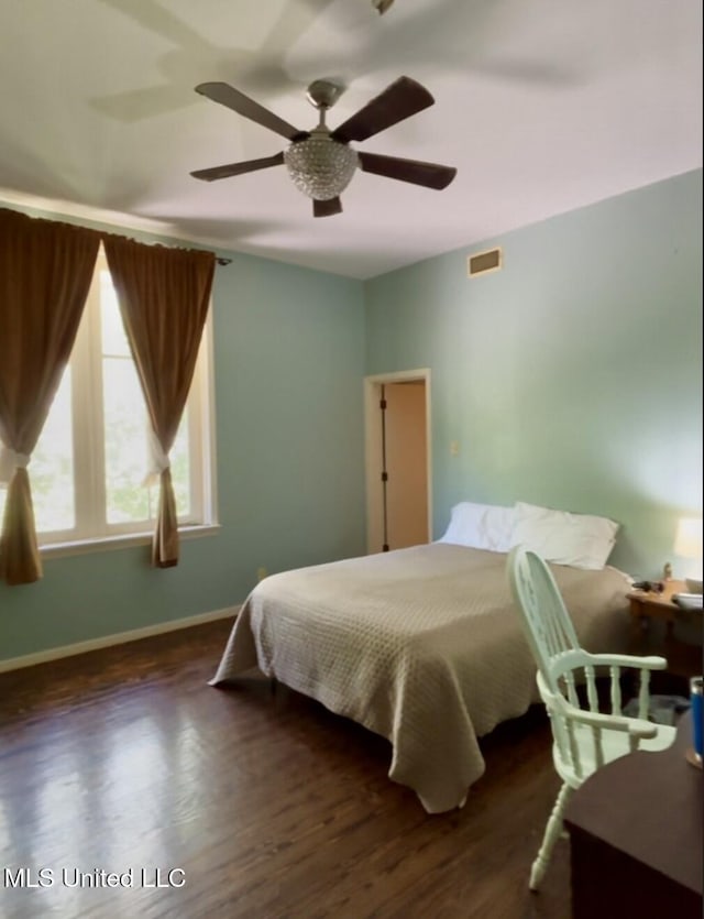 bedroom with ceiling fan, baseboards, visible vents, and wood finished floors