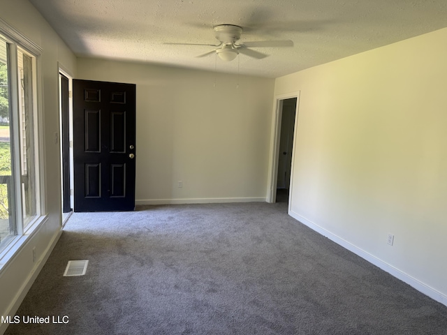 661 Robinhood Rd, Jackson, MS 39206 - empty room featuring a ceiling fan, dark carpet, a textured ceiling, and baseboards