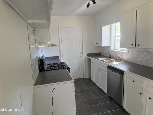 661 Robinhood Rd, Jackson, MS 39206 - kitchen with stainless steel dishwasher, a sink, gas range oven, tile counters, and decorative backsplash
