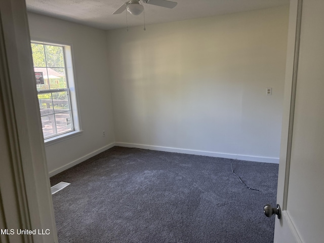 661 Robinhood Rd, Jackson, MS 39206 - unfurnished room with dark colored carpet, a ceiling fan, and baseboards