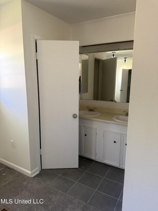 661 Robinhood Rd, Jackson, MS 39206 - bathroom with double vanity, tile patterned floors, and ornamental molding