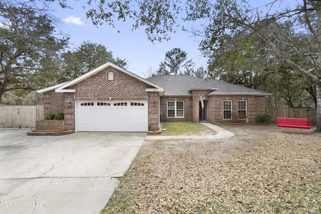 single story home with a garage, driveway, brick siding, and fence