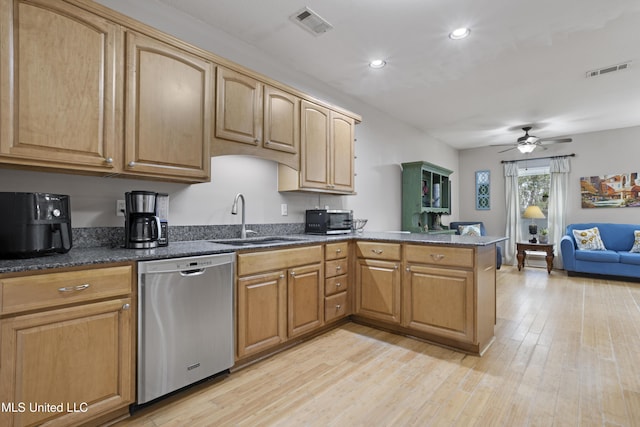 kitchen featuring visible vents, dishwasher, a peninsula, light wood-type flooring, and a sink