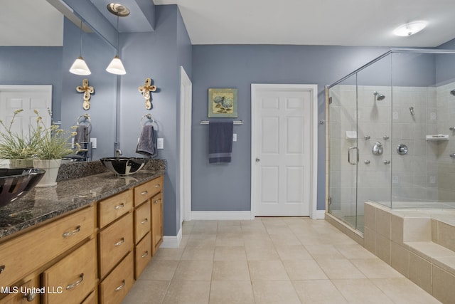 full bathroom featuring baseboards, a stall shower, vanity, and tile patterned floors