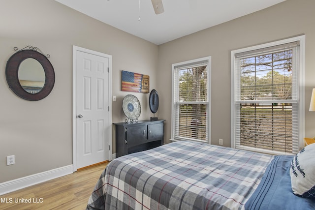 bedroom featuring ceiling fan, wood finished floors, and baseboards