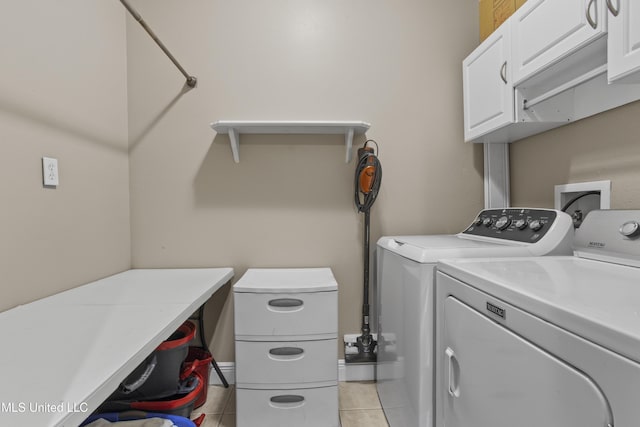 washroom with cabinet space, light tile patterned floors, and separate washer and dryer