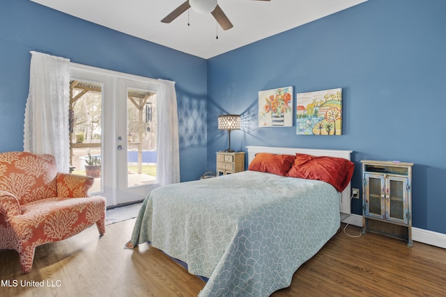 bedroom with access to exterior, french doors, a ceiling fan, wood finished floors, and baseboards