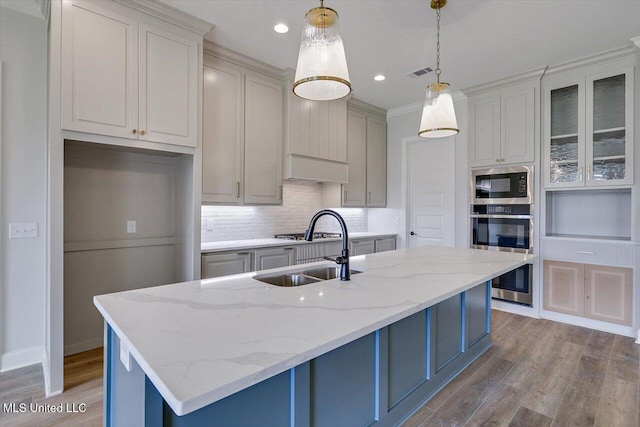 104 Brents Xing, Clinton, MS 39056 - kitchen featuring a sink, black microwave, wood finished floors, decorative backsplash, and recessed lighting