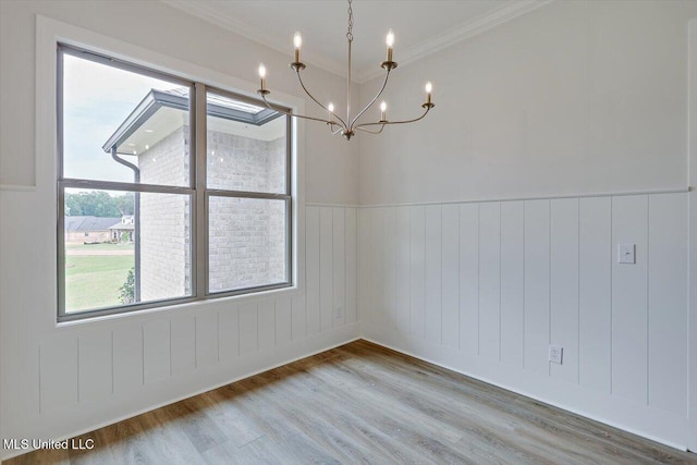 104 Brents Xing, Clinton, MS 39056 - unfurnished room with a chandelier, wood finished floors, crown molding, and wainscoting