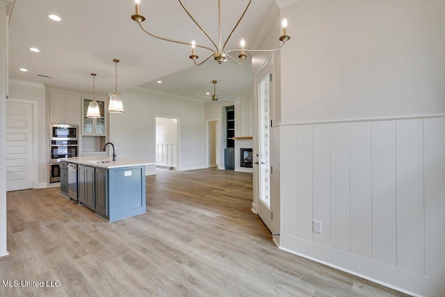 104 Brents Xing, Clinton, MS 39056 - kitchen with appliances with stainless steel finishes, a sink, light countertops, a kitchen island with sink, and crown molding