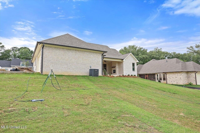 104 Brents Xing, Clinton, MS 39056 - back of house with central air condition unit, a yard, and brick siding