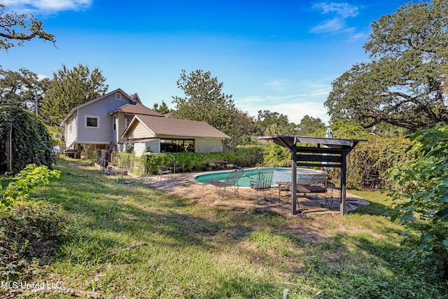 view of swimming pool featuring a patio area and a lawn