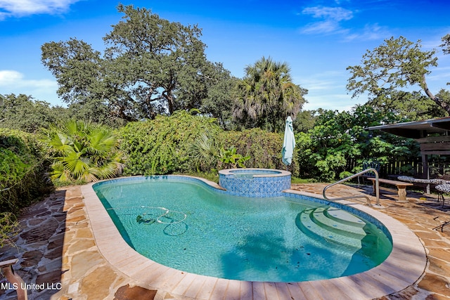 view of pool featuring a patio area and an in ground hot tub